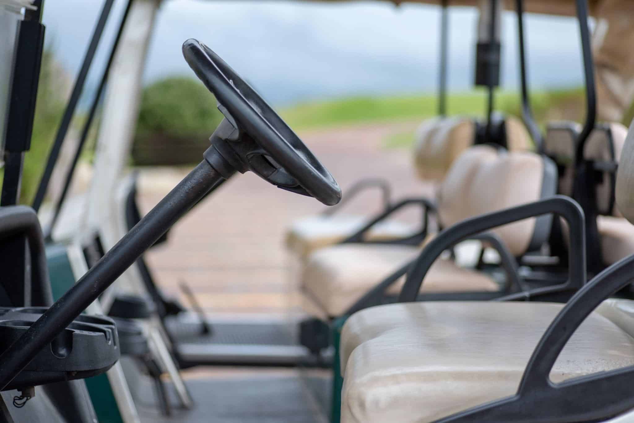 Golf cart steering wheel and seats ready for a day of island exploring.
