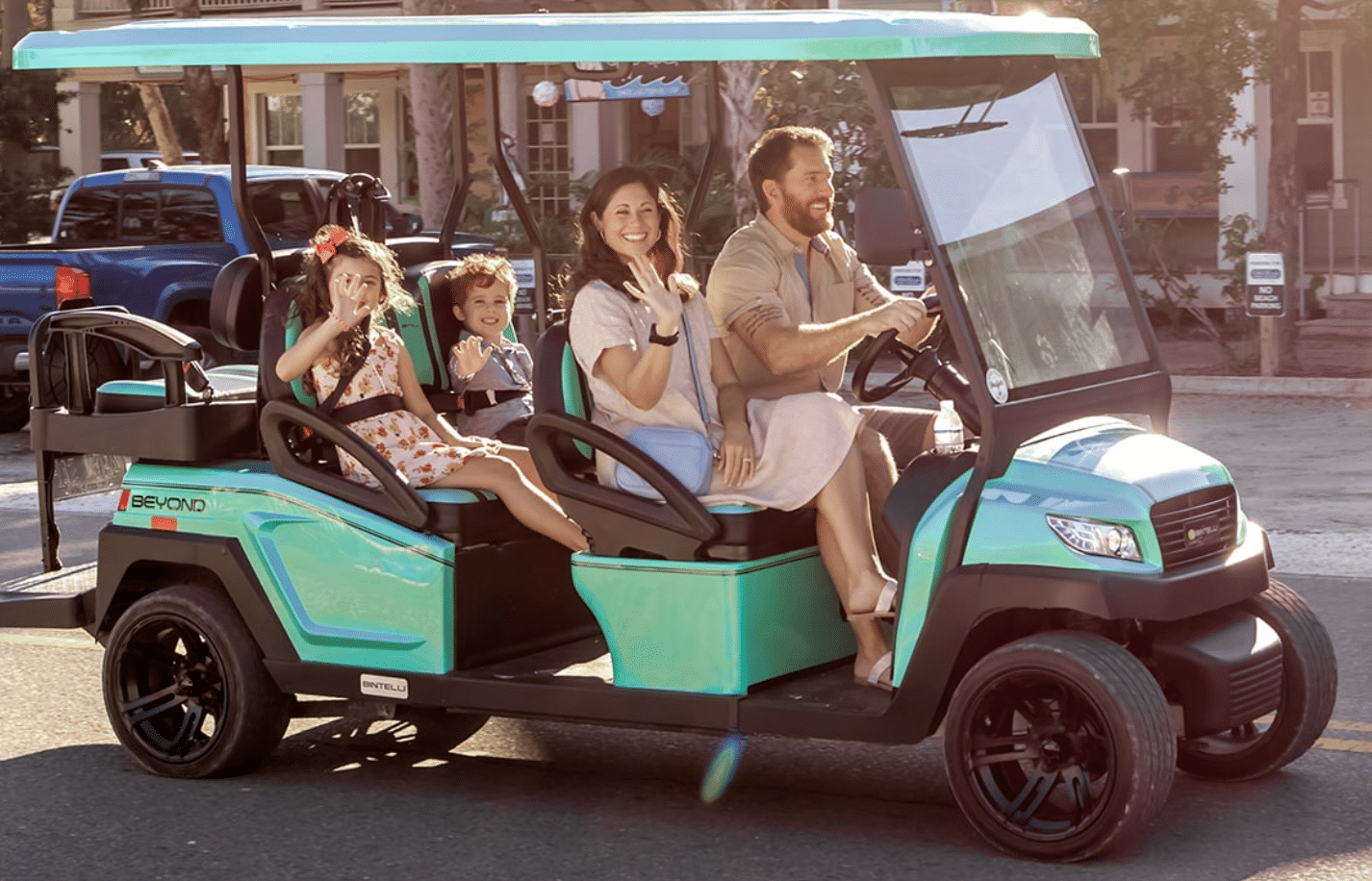 Happy family cruising Anna Maria Island in a premium golf cart rental, the easy way to explore.
